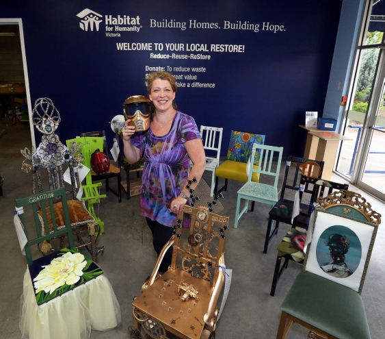 Yolanda Meijer shows off some of the decorated chairs at the new ReStore outlet. Photograph By BRUCE STOTESBURY, Times Colonist - See more at: http://www.timescolonist.com/business/artful-idea-opens-habitat-s-newest-restore-on-oak-street-1.2031594#sthash.CyY96nFW.dpuf