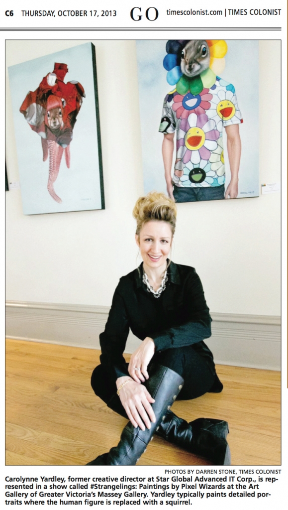 Carollyne Yardley in front of paintings for #Strangelings: Paintings by Pixel Wizards. Photo by Darren Stone, Times Colonist. Oct 17, 2013.