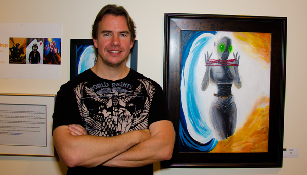 Paul Dowd with his artwork. Photo by Matthew Schlauch, Snapd Magazine, Dec 2013.